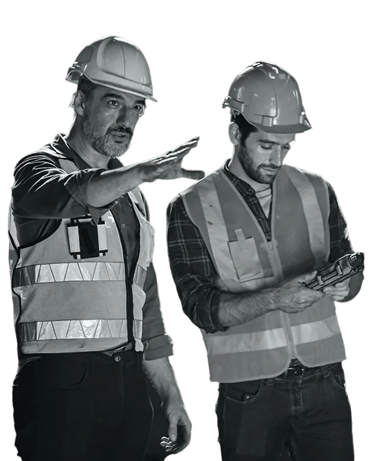 Two construction workers reviewing a plan on site