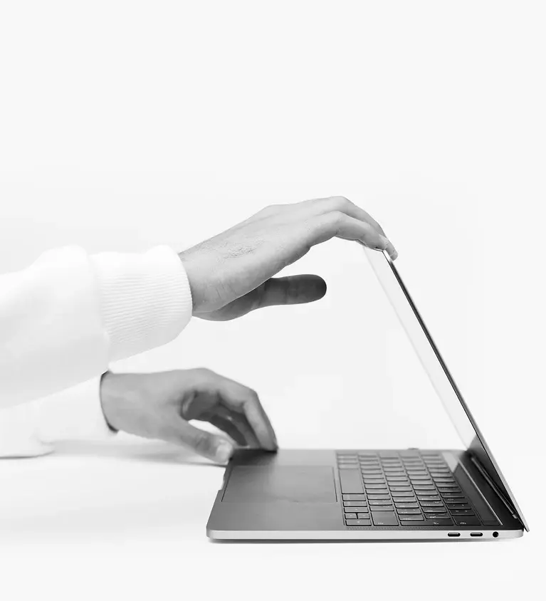 Hands opening a laptop