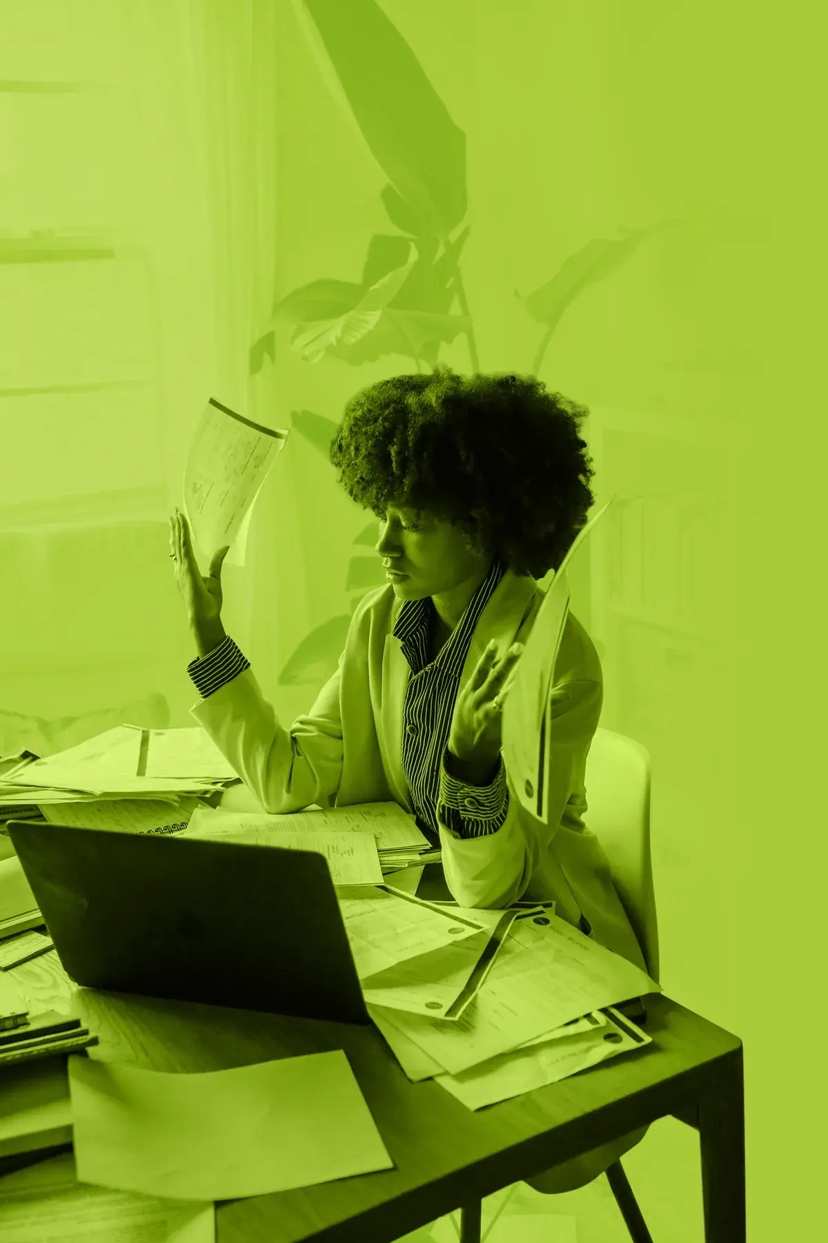 Business owner overwhelmed by paperwork at their desk